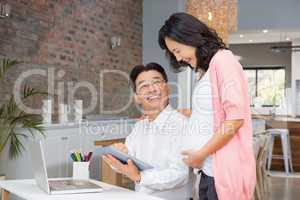 Happy couple using tablet