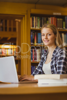 Smiling student working on laptop