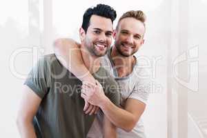 Smiling gay couple hugging