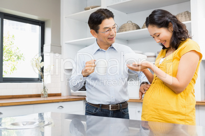 Happy expectant couple in the kitchen