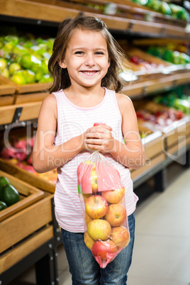 Portrait of little girl holding apple