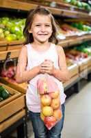 Portrait of little girl holding apple