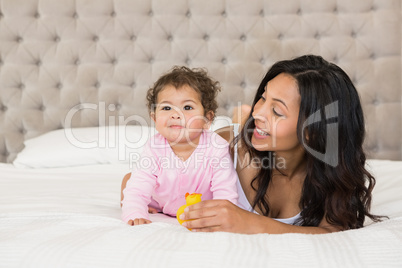 Brunette playing with her baby and a duck