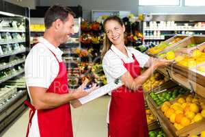 Grocery store staff with clipboard