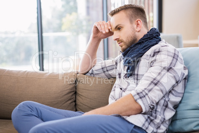 Worried man thinking on the couch