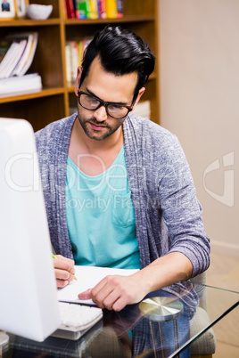 Serious designer working at the desk