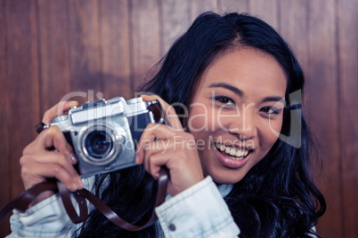 Asian woman holding digital camera