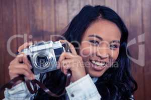 Asian woman holding digital camera