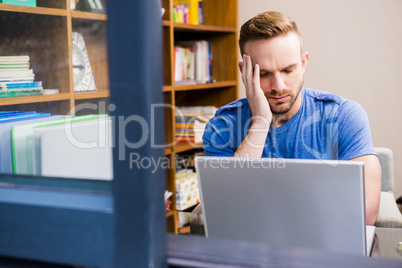 Serious designer working on computer