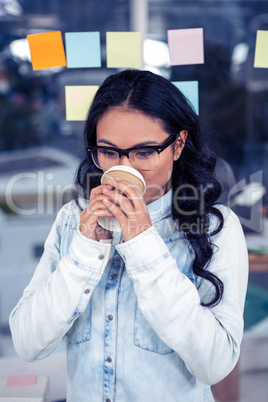 Asian woman drinking by disposable cup