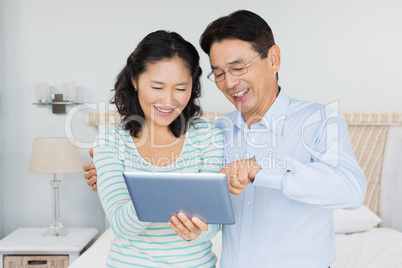 Happy couple using tablet