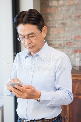 Serious man using smartphone