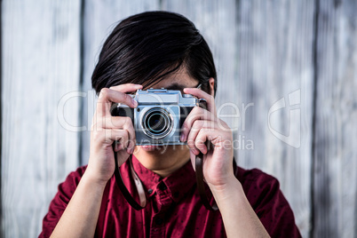 Hipster taking pictures with an old camera