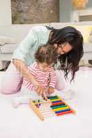 Mother and baby playing with abacus