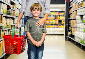 Cute boy doing grocery shopping with mother