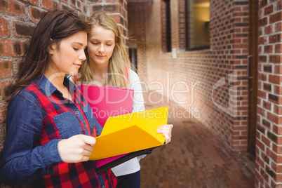 Smiling students reading book