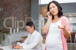 Smiling pregnant woman on a phone call