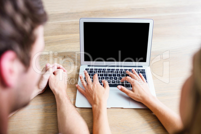 Focused couple using laptop