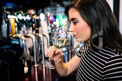 Attractive woman smelling white wine