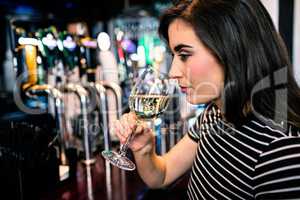 Attractive woman smelling white wine
