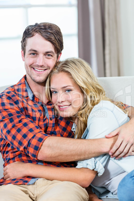 Couple hugging on the couch