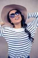 Smiling Asian woman with hat and sunglasses