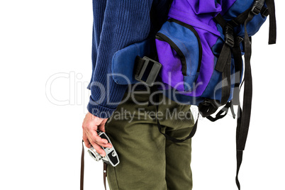 Midsection of backpacker hipster holding camera