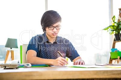 Focused hipster businessman writing