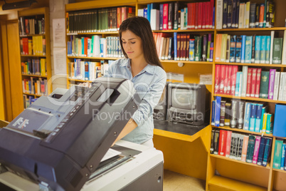 Smiling brunette student making a copy