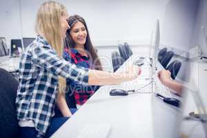 Smiling students using computer