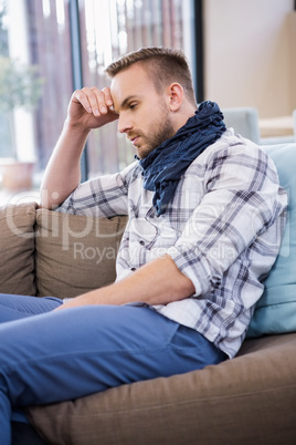 Worried man thinking on the couch