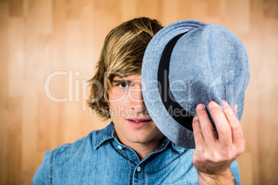Focused hipster man hiding his face