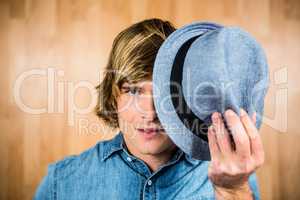 Focused hipster man hiding his face