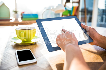 Cropped image of hipster businessman using tablet