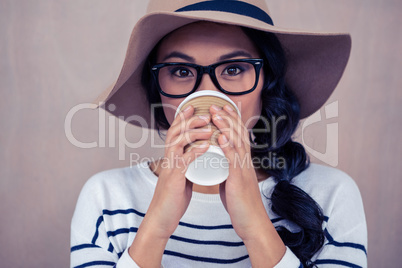 Attractive Asian woman drinking by disposable cup