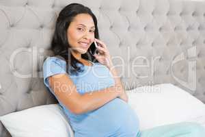 Pregnant brunette on phone call