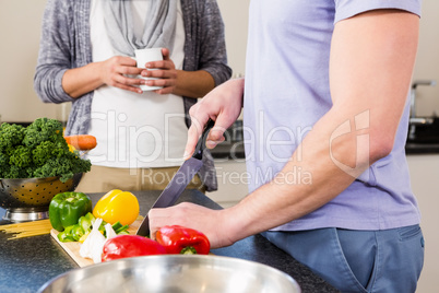 Mid section of gay couple preparing food