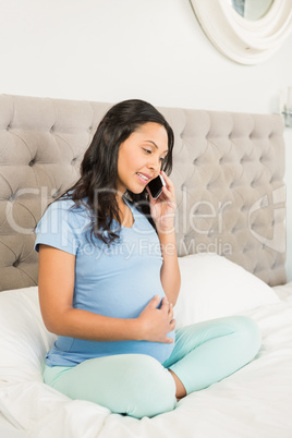 Pregnant brunette on phone call