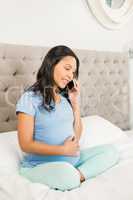 Pregnant brunette on phone call