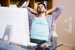 Handsome designer man relaxing at the desk