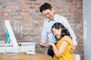 Happy couple using tablet