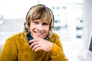 Smiling hipster businessman using headset
