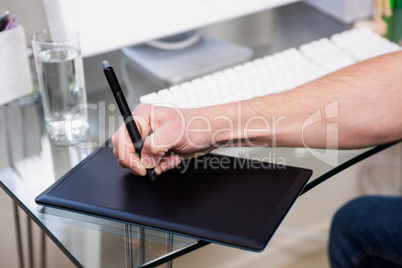 Cropped image of man using graphic tablet