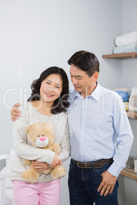 Smiling couple with teddy bear