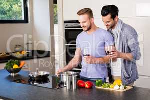 smiling gay couple preparing food