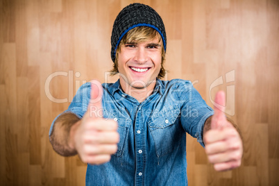 Smiling hipster with thumbs up