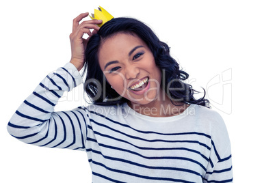 Smiling Asian woman with paper crown