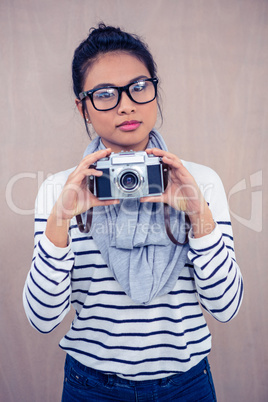 Attractive Asian woman holding camera