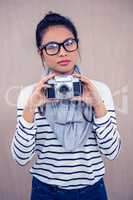 Attractive Asian woman holding camera
