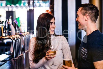 Cute couple talking in a bar